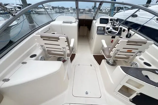 Slide: The Image of 2008 Scout 242 Dorado boat interior with dual helm seats and dashboard controls. - 13