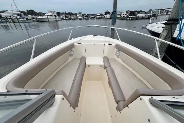 Slide: The Image of 2008 Scout 242 Dorado boat with spacious seating, docked in a marina. - 14