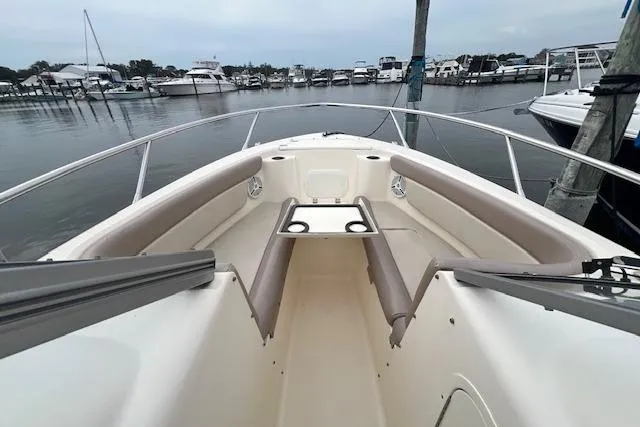 Slide: The Image of 2008 Scout 242 Dorado boat docked in a marina, featuring spacious seating and sleek design. - 15
