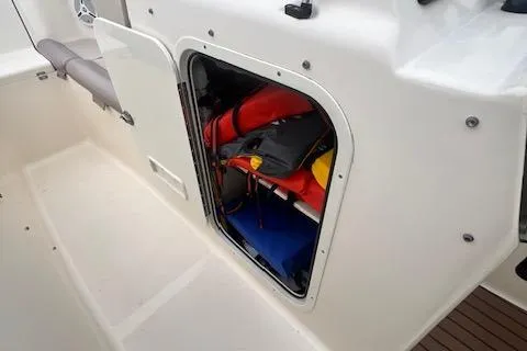 Slide: The Image of Storage compartment on a 2008 Scout 242 Dorado boat, containing safety equipment. - 21