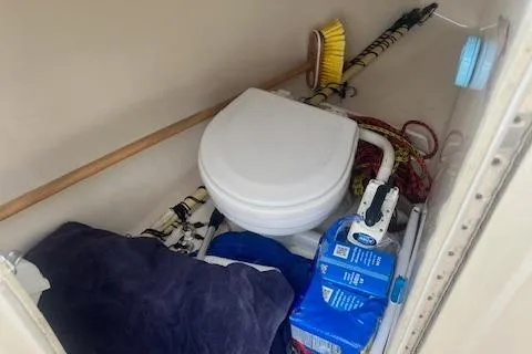 Slide: The Image of 2008 Scout 242 Dorado boat interior with toilet and cleaning supplies. - 22