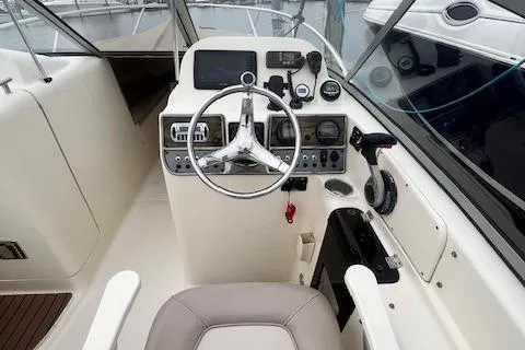 Slide: The Image of 2008 Scout 242 Dorado boat cockpit with steering wheel and control panel. - 6