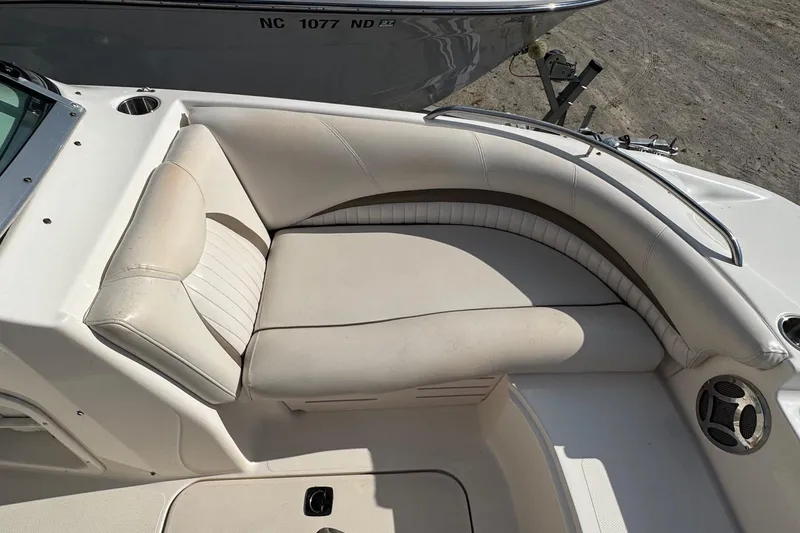 Slide: The Image of 2008 Hurricane SunDeck 195 OB boat interior with beige seating and cup holder. - 12