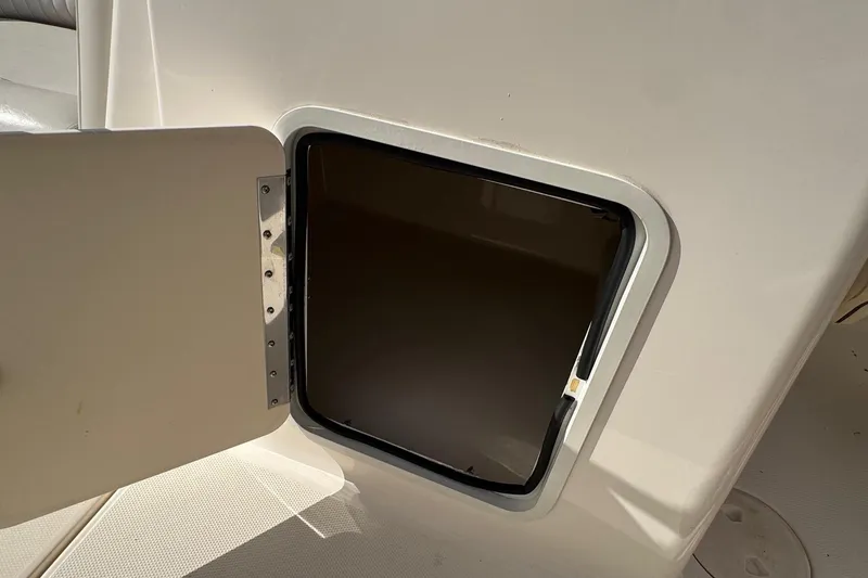Slide: The Image of Open storage compartment on a 2008 Hurricane SunDeck 195 OB boat. - 17