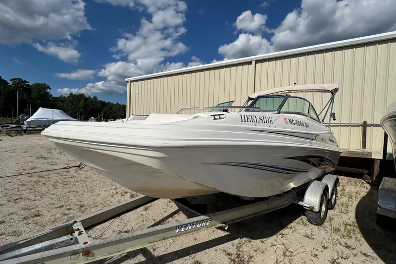 Slide: The Image of 2008 Hurricane SunDeck 195 OB boat on trailer, parked outdoors under a blue sky. - 3