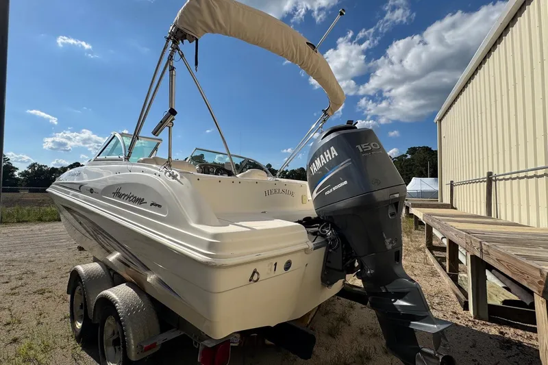 Slide: The Image of 2008 Hurricane SunDeck 195 OB boat with Yamaha 150 engine, parked outdoors. - 4