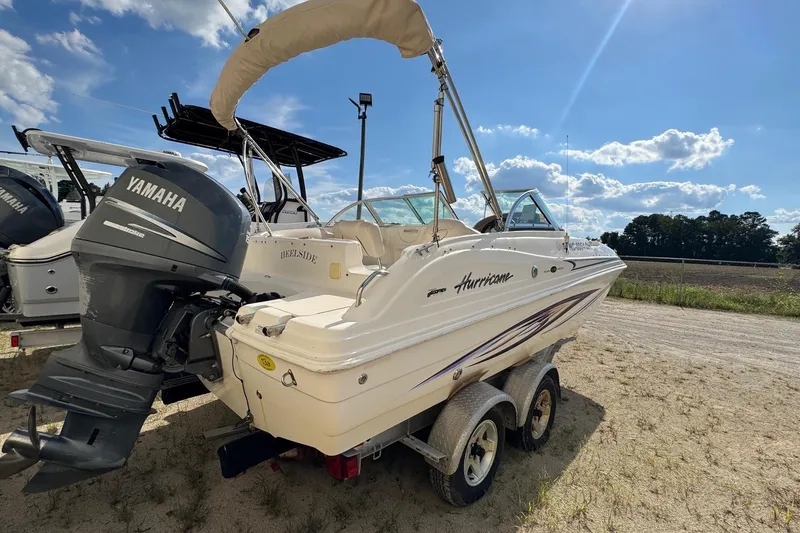 Slide: The Image of 2008 Hurricane SunDeck 195 OB boat with Yamaha outboard motor on a trailer. - 5