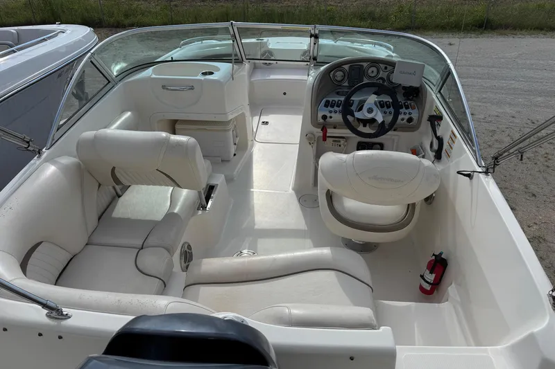 Slide: The Image of 2008 Hurricane SunDeck 195 OB boat interior with white seating and steering console. - 6