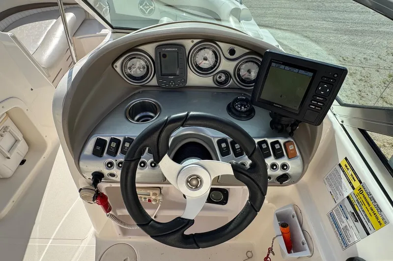 Slide: The Image of Dashboard of a 2008 Hurricane SunDeck 195 OB boat with steering wheel and navigation instruments. - 7
