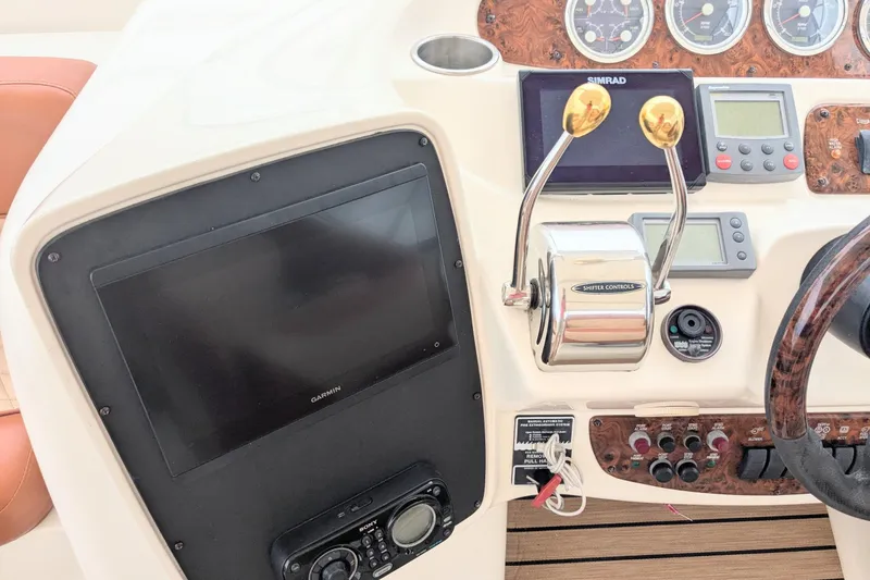 Slide: The Image of Control panel of a 2004 Meridian 411 yacht with navigation and throttle controls. - 12