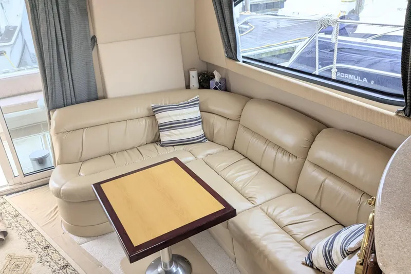 Slide: The Image of Luxurious interior of 2004 Meridian 411 yacht with leather seating and wooden table. - 16