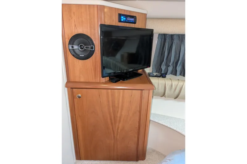 Slide: The Image of 2004 Meridian 411 interior with TV, speaker, and wooden cabinet. - 22