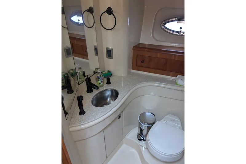 Slide: The Image of Luxurious bathroom in 2004 Meridian 411 yacht with sink, mirror, and toilet. - 25