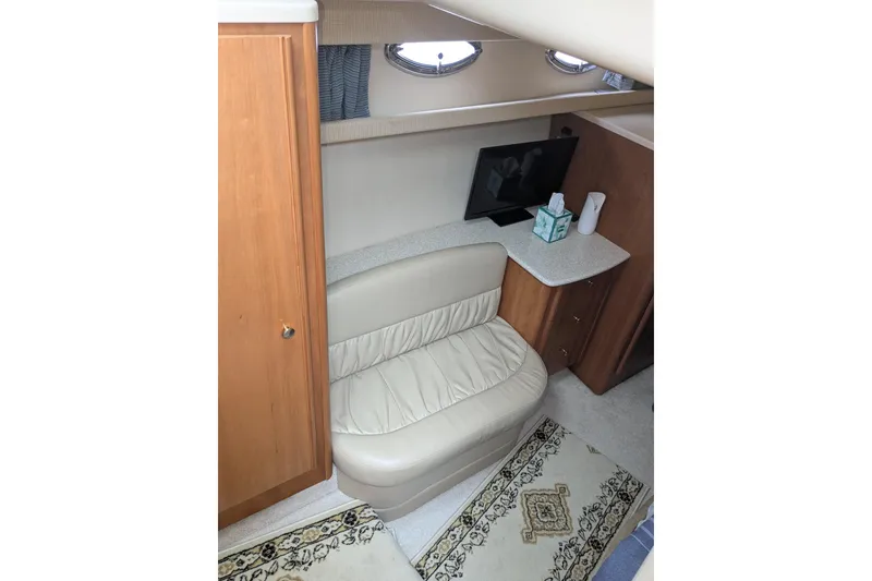 Slide: The Image of Interior of 2004 Meridian 411 yacht with seating, TV, and wooden cabinetry. - 26