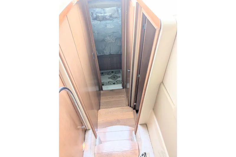 Slide: The Image of Stairway leading to cabin interior of 2004 Meridian 411 yacht. - 28