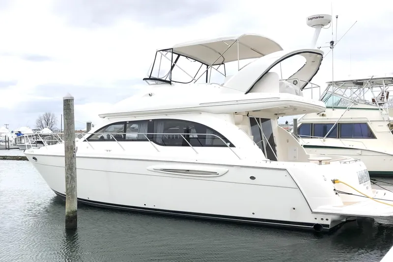 Slide: The Image of 2004 Meridian 411 yacht docked in a marina, featuring a sleek white design. - 37