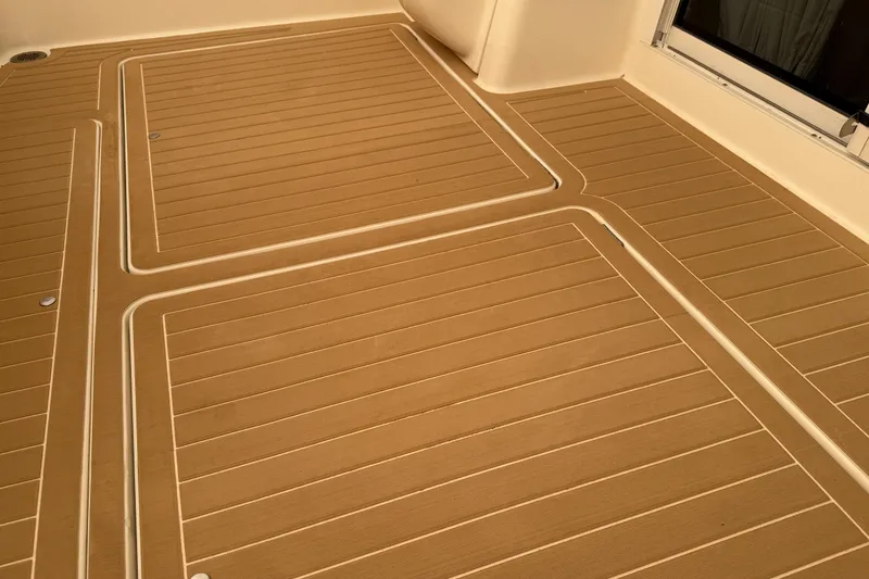 Slide: The Image of Teak deck of 2004 Meridian 411 yacht, featuring clean lines and smooth finish. - 38