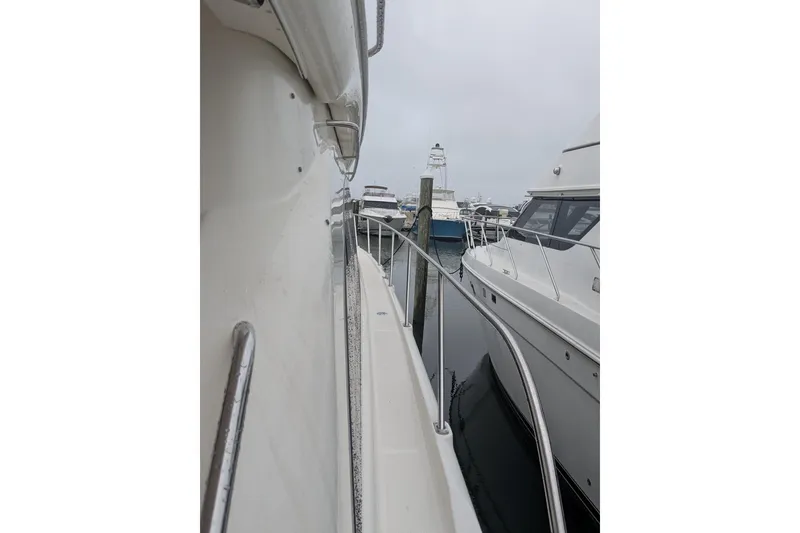 Slide: The Image of 2004 Meridian 411 yacht docked in a marina, side view with railing. - 5