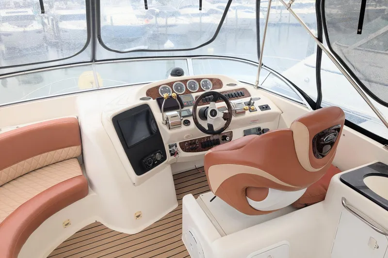 Slide: The Image of Luxurious 2004 Meridian 411 yacht helm with leather seating and modern controls. - 9