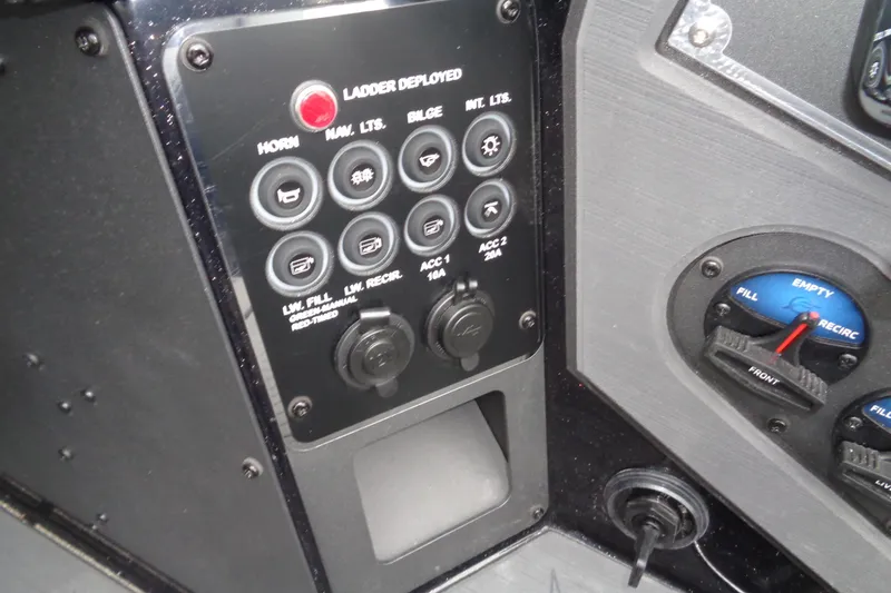 Slide: The Image of Control panel of 2026 Vexus DVX22S boat with various switches and indicators. - 10