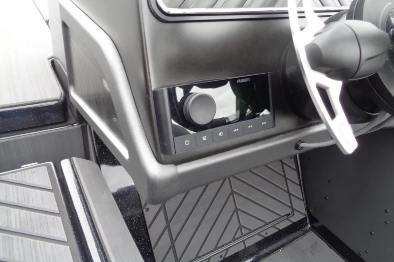 Slide: The Image of 2026 Vexus DVX22S boat dashboard with Fusion audio system and steering wheel detail. - 13