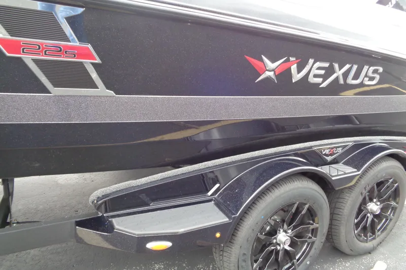 Slide: The Image of 2026 Vexus DVX22S boat with sleek black design and dual axle trailer. - 6