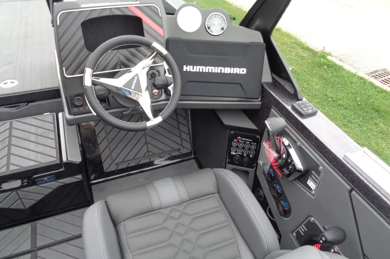 Slide: The Image of 2026 Vexus DVX22S boat cockpit with steering wheel, Humminbird system, and control panel. - 9