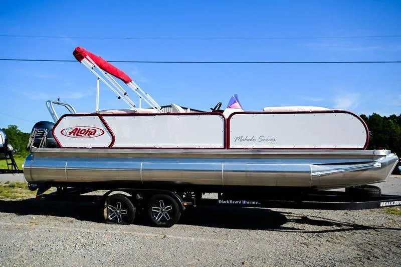 The Image of 2022 Aloha Pontoon Mahalo 23 on trailer, featuring sleek design and vibrant red accents. - 0