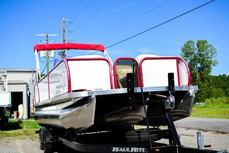 Slide: The Image of 2022 Aloha Pontoon Mahalo 23 on trailer, featuring red accents and canopy. - 2