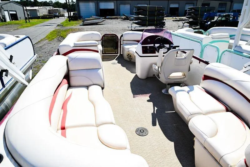 Slide: The Image of 2022 Aloha Pontoon Mahalo 23 with spacious seating and modern helm, docked outdoors. - 5