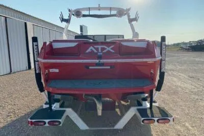 Slide: The Image of 2026 ATX Surf Boats 22 Type-S, red, rear view near storage facility. - 4