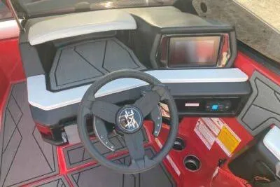 Slide: The Image of 2026 ATX Surf Boats 22 Type-S dashboard with steering wheel and touchscreen display. - 6