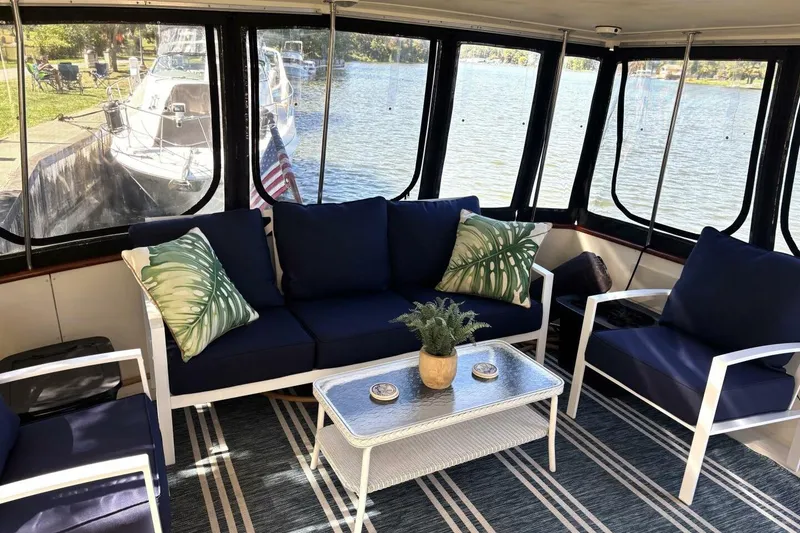 Slide: The Image of Cozy interior of 1987 Viking 44 Motor Yacht with blue seating and lake view. - 3