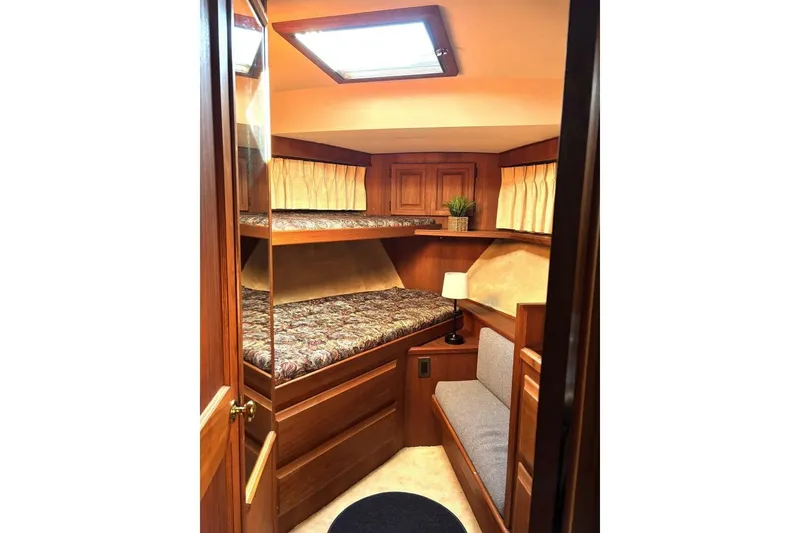 Slide: The Image of Cozy cabin interior of 1987 Viking 44 Motor Yacht with wooden furnishings and bunk beds. - 8