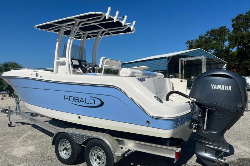 Slide: The Image of 2024 Robalo R222 Center Console boat with Yamaha engine on trailer. - 1