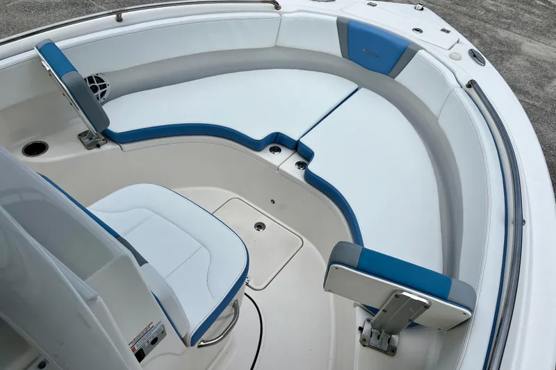 Slide: The Image of 2024 Robalo R222 Center Console boat interior with blue and white seating. - 13