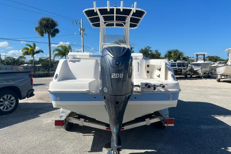 Slide: The Image of 2024 Robalo R222 Center Console boat with Yamaha 200 engine, parked outdoors. - 2