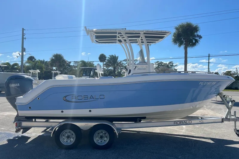 Slide: The Image of 2024 Robalo R222 Center Console boat on trailer, side view, sunny day. - 5