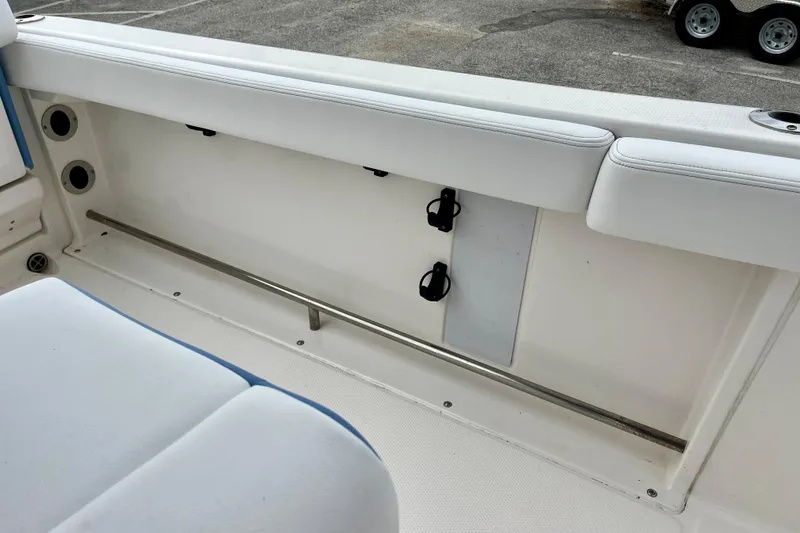 Slide: The Image of 2024 Robalo R222 Center Console boat interior with white seating and storage area. - 9