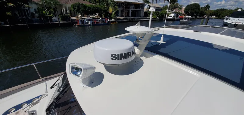 Slide: The Image of 2023 Greenline 40 yacht with Simrad radar, docked by a scenic waterfront. - 11