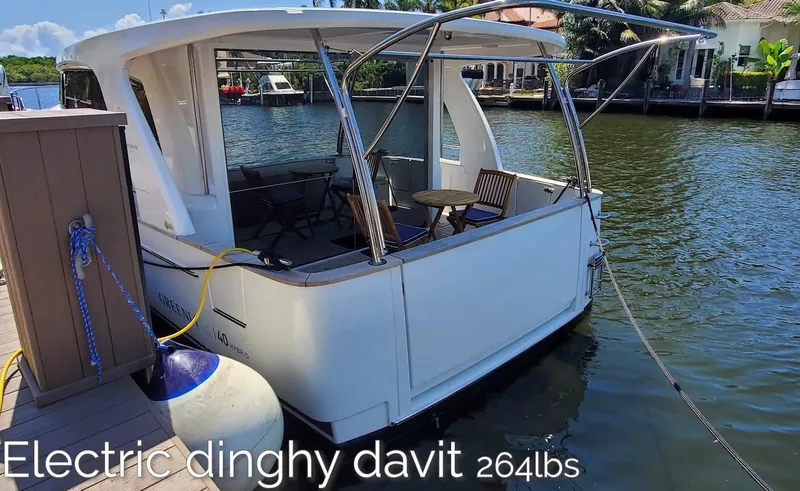 Slide: The Image of 2023 Greenline 40 yacht with electric dinghy davit, docked by the water. - 15