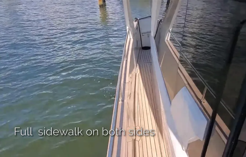 Slide: The Image of 2023 Greenline 40 yacht with full sidewalk on both sides, cruising on water. - 16