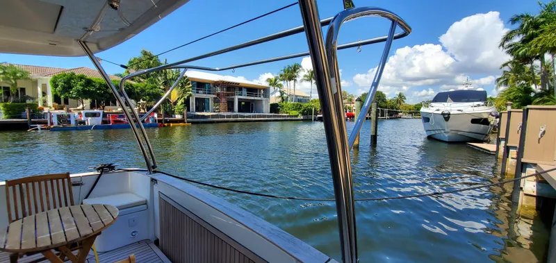 Slide: The Image of 2023 Greenline 40 yacht docked in a scenic marina with clear skies. - 17