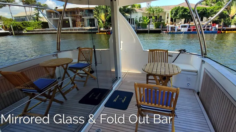 Slide: The Image of 2023 Greenline 40 yacht with mirrored glass and fold-out bar on deck. - 19