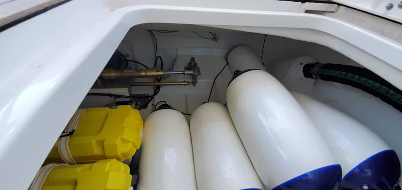 Slide: The Image of Storage compartment of 2023 Greenline 40 yacht with white fenders and yellow equipment. - 23