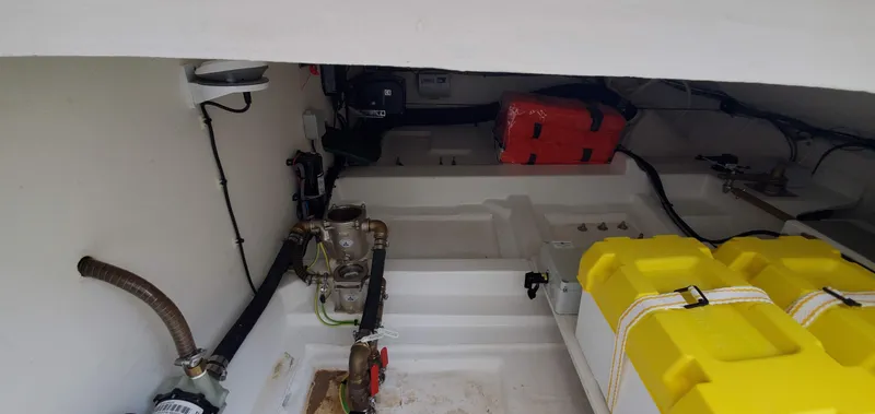 Slide: The Image of Engine compartment of 2023 Greenline 40 boat with visible components and yellow storage containers. - 25