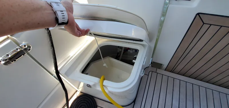 Slide: The Image of Open storage compartment on 2023 Greenline 40 boat with deck view. - 27