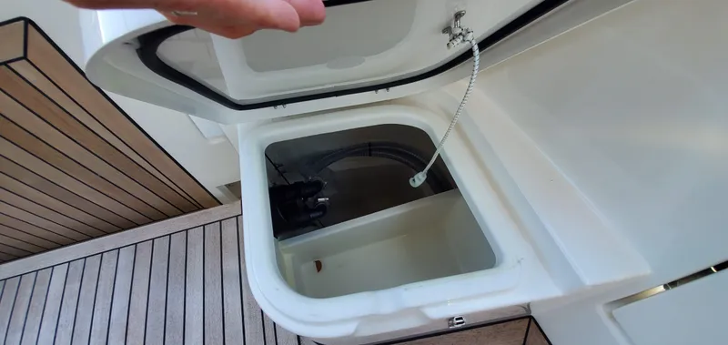 Slide: The Image of Open storage compartment on 2023 Greenline 40 yacht with visible interior components. - 29