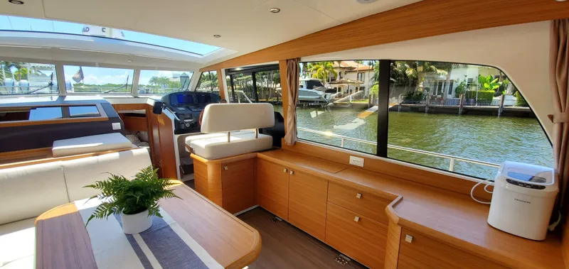 Slide: The Image of Interior of 2023 Greenline 40 yacht with modern design and large windows overlooking water. - 33