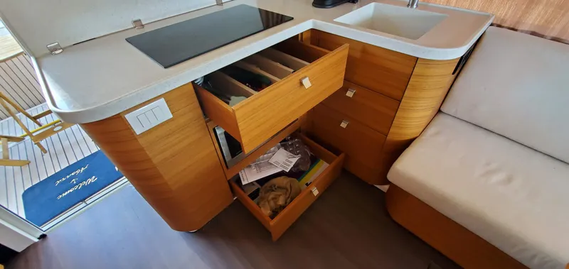 Slide: The Image of Modern kitchen area in 2023 Greenline 40 yacht with open drawers and sleek design. - 35